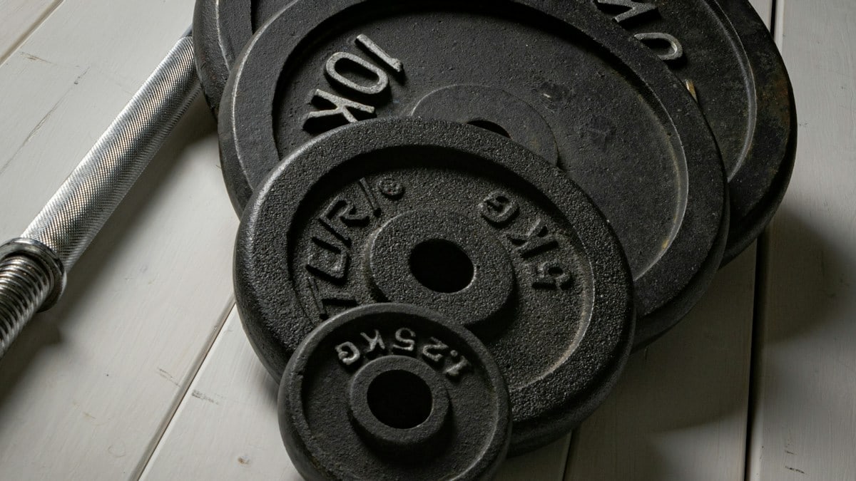 Weight plates and barbell setup for strength training at home. Fitness gear I would use → linktr.ee/alexsaks.inspiration